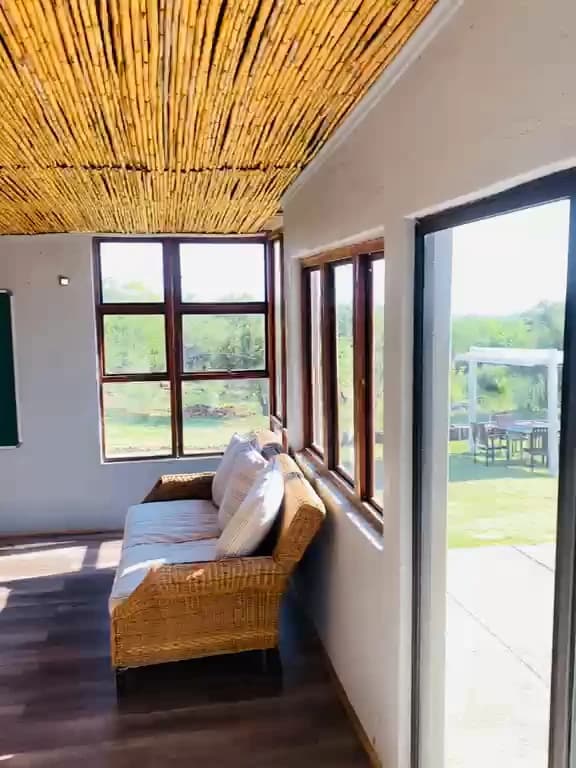 Frame from the property walkthrough showing the sunlit living area and windows